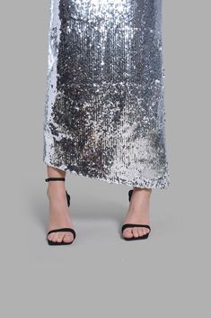 This mid-rise Silver Sequin Diagonal Maxi Skirt has an asymmetrical cut at the bottom. This skirt is noted for its uniqueness in design and its versatility. This product is styled with the Black Satin Arc-Cut Top. Long Skirt For Cocktail And Party Season, Long Skirt For Cocktail Party Season, Cocktail Long Skirt For Party Season, Asymmetrical Skirt For Spring Party, Spring Party Ankle-length Skirt, Asymmetrical Party Skirt With Lining, Party Asymmetrical Lined Skirt, Asymmetrical Lined Party Skirt, Spring Party Draped Asymmetrical Skirt