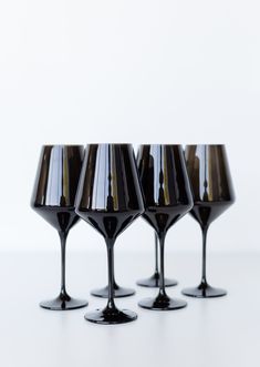 four wine glasses sitting on top of each other