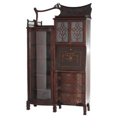 an antique wooden armoire with glass doors