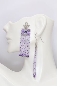 Swoon worthy sweet lavender, purple, and silver boho seed bead earrings featuring a dainty flower pattern with confetti on the swaying fringe. They were inspired by a beautiful bouquet I saw, and I wanted to share that beauty and the happiness the colors brought me with you. These are OOAK. Handmade by me in my home studio.Size 2 7/8 inches long5/8 inch wide2 1/4 inch drop Elegant Lavender Beaded Earrings With Dangling Beads, Elegant Lavender Beaded Earrings, Lavender Beaded Dangle Earrings, Lavender Adjustable Dangle Beaded Earrings, Purple Beaded Fringe Earrings As Gift, Purple Beaded Fringe Earrings For Gift, Purple Jewelry With Beaded Fringe And Round Beads, Purple Beaded Fringe Drop Earrings, Bohemian Lavender Earrings With Dangling Beads