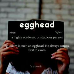 a woman holding up a sign that says egghead on the side of her face