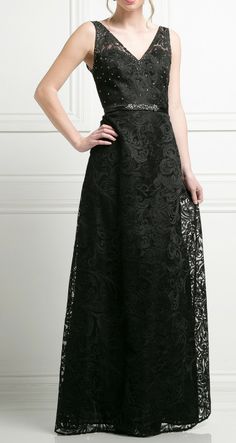 a woman wearing a black dress with lace detailing