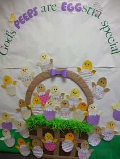 an easter decoration with peeps and eggs in the basket on display for children to see