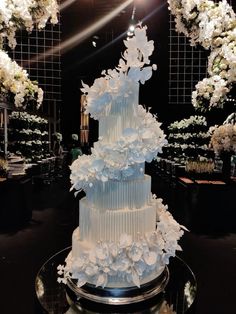 a wedding cake with white flowers on top