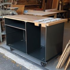 a workbench sitting in the middle of a garage with tools on it's wheels