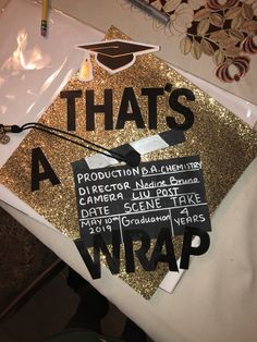 a graduation cap that has been decorated with black and gold letters