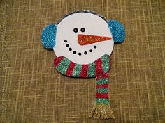 a snowman ornament on a brown background