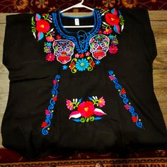 a black shirt with colorful flowers on it