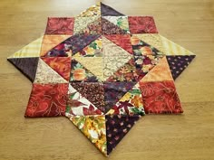 a patchwork quilt is laying on the floor with it's center piece missing