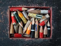 a box filled with lots of different colored pencils