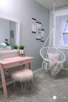 a pink desk and chair in a room with gray carpeted flooring, white walls and windows