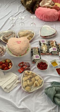 a table topped with lots of food and desserts