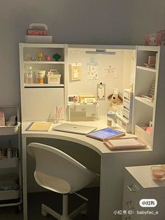 a white desk with a laptop on top of it next to a shelf filled with items