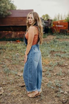 The Flynn Overalls offer a stylish and versatile option for your fall wardrobe. With a barrel jean fit and loose silhouette, these cowgirl overalls provide both comfort and fashion. Made from durable denim, they are perfect for back to school or any casual occasion. Courtney is wearing size small paired with The Kristan Tank Cowgirl Overalls, Homestead Outfits, Jean Overall Outfits, Jean Fit, Overalls Men, Overall Outfit, Jean Overalls, Curvy Dress, Fall Wardrobe