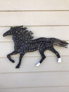 a metal horse on the side of a building