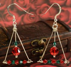 Metal - Sterling Silver Color- Christmas Red and Green Crystals Length is about 2 inches long. Made with Sterling Silver & Swarovski Crystal Elements Very simple and elegant Earrings for Christmas time. Show your holiday spirit with these Christmas colored Earrings. These gleaming drop earrings are carefully handcrafted and dangle right on the French-wire. We Ship this item in a gift box. Holiday Beaded Jewelry, Holiday Jewelry Ideas, Christmas Red And Green, Easy Crafts To Sell, Wire Wrap Jewelry Designs, Wire Wrapped Jewelry Diy, Colored Earrings, Holiday Beading