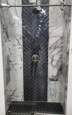 the shower is made up of black and white marble