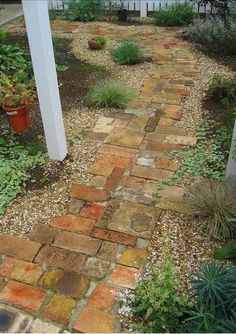 a brick path leading to a white house