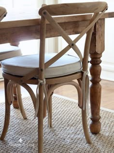 a wooden chair sitting on top of a rug