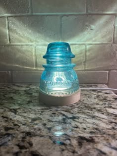 a blue glass jar sitting on top of a counter