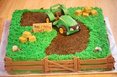 a birthday cake made to look like a farm scene with tractor and hay on the ground