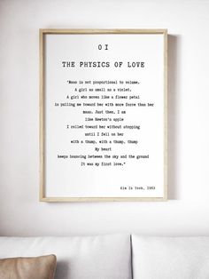 the physics of love poem framed in a living room with white couches and pillows