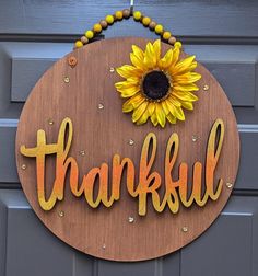 a wooden sign that says, thank with a sunflower on it