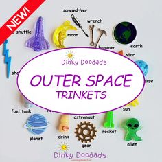 the outer space trinkets are displayed in front of a white sign that says dinky doodads