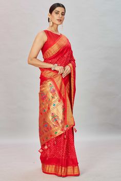 Look royal at weddings and special occasions in this stunning red bandhani kanchipuram saree with Paithani pallu. It comes with a blouse piece. Disclaimer: The shown stitched blouse on the model is for display purpose only. The saree comes with a matching blouse piece and finished with fall and piko. Red Pre-draped Saree With Traditional Patterns For Navratri, Traditional Red Pre-draped Saree With Zari Weaving, Red Paithani Silk Pre-draped Saree For Puja, Red Art Silk Pre-draped Saree With Self Design, Festive Red Pre-draped Saree With Pallu, Red Chanderi Pre-draped Saree With Zari Weaving, Red Bandhani Print Traditional Drape, Red Zari Weaving Traditional Wear For Navratri, Red Traditional Wear With Zari Weaving For Navratri