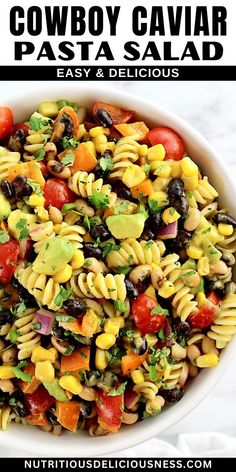 a white bowl filled with pasta salad on top of a table