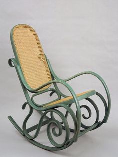 a green rocking chair with wicker seat and arm rests on a white background,