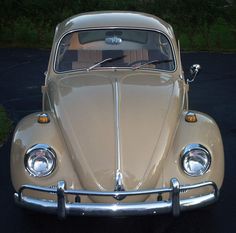 an old vw bug parked in a parking lot