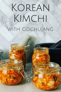 three jars filled with food sitting on top of a counter