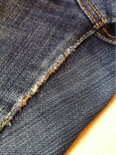 the back pocket of a pair of blue jeans with holes in it's side