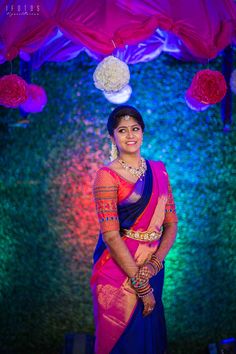 a woman in a pink and blue sari