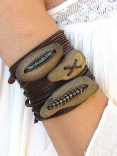 a woman wearing a bracelet made out of wooden beads and leather cord with buttons on it