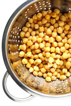 a large metal colander filled with chickpeas