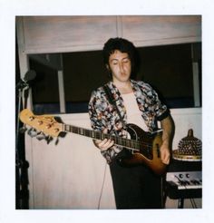 a young man is playing an electric guitar