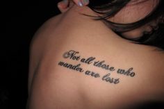 a woman with a tattoo saying not all those who wander are lost on her back