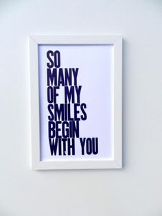 a white framed print with the words so many of my smiles begin with you