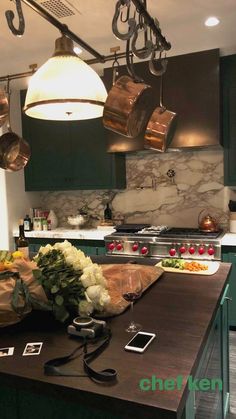 the kitchen is clean and ready to be used for cooking or eating, with pots hanging from the ceiling