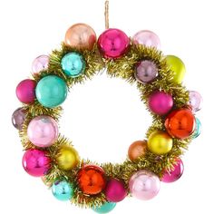 a colorful christmas ornament with tinsel and ornaments hanging from it's side