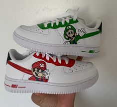 Mario and Luigi Super Mario Bros Custom Air Force shoes, painted with the highest quality shoe paint. The paint will not scratch or chip off easily. Please feel free to message me for any changes you want made to the shoes. To check out my other designs check out my IG: fortheart_LZ MESSAGE ME FOR DISCOUNT! Mario Painted Shoes, Costom Shoes, Mario Shoes, Baby Jordan Shoes, Mario Und Luigi, Custom Sneakers Diy, Air Force Shoes, Nike Air Force 1 Custom, Custom Painted Shoes