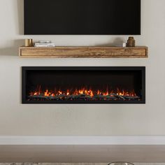 an electric fireplace in a living room with a flat screen tv on the wall above it