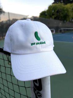 "The perfect gift for a pickle ball champ or any pickle lover.  * 100% chino cotton twill * Unstructured, 6-panel, low-profile * 6 embroidered eyelets * 3 ⅛\" (7.6 cm) crown * Adjustable strap with antique buckle This product is made especially for you as soon as you place an order, which is why it takes us a bit longer to deliver it to you.  RETURNS AND EXCHANGES * All sales are final unless the item arrives damaged * If your item arrives damaged, please contact us within 28 days of receiving Casual Snapback Trucker Hat For Pickleball, White Cotton Hats With Custom Embroidery, Embroidered Cotton Trucker Hat With Flat Bill, Summer Dad Hat With Embroidered Logo And Flat Bill, Casual Cotton Baseball Cap With Custom Embroidery, Casual Cotton Trucker Hat With Custom Embroidery, Cotton Dad Hat With Letter Embroidery For Baseball Season, Casual Summer Hats For Pickleball, White Cotton 5-panel Dad Hat