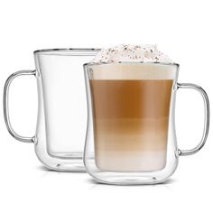 two clear mugs filled with coffee and topped with whipped cream on the inside one