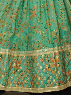 Real beauty comes out from your dressing style with this beautiful green color lehenga assembled with organza material performed with thread embroidery, sequins work, floral print, and dori work. This green lehenga comes with a similar color art silk material choli created with digital print and embroidery. It also comes with a similar color organza material dupatta made with lace border and sequins work. This wonderful green floral printed lehenga is semi-stitched can fit up to 42 inches and co Green Floral Embroidery Anarkali Set For Party, Green Chanderi Lehenga With Zari Work, Unstitched Green Lehenga With Resham Embroidery, Green Anarkali Set With Zari Work In Organza, Green Organza Lehenga With Zari Work, Semi-stitched Floral Print Lehenga For Eid, Green Lehenga With Dupatta In Organza, Green Organza Lehenga For Eid, Green Organza Anarkali Lehenga