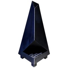 a black metal object that is in the shape of a cone and has four small white objects inside it