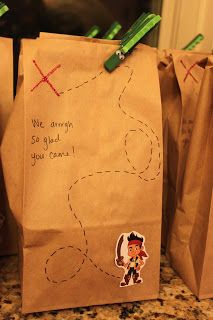 two brown paper bags with stickers on them sitting on a counter next to each other