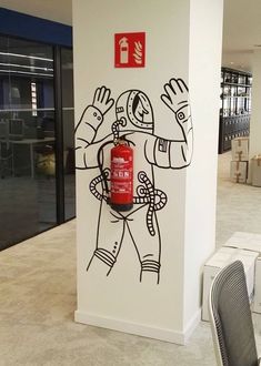 a fire extinguisher painted on the side of a wall in an office